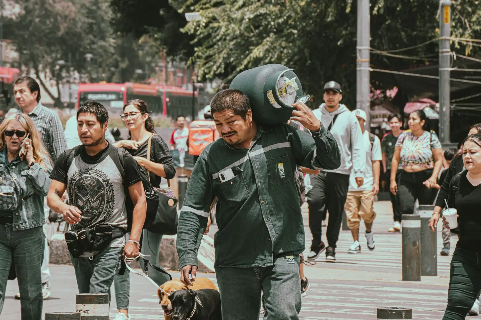 People walking on a bustling city street, engaged in various activities.