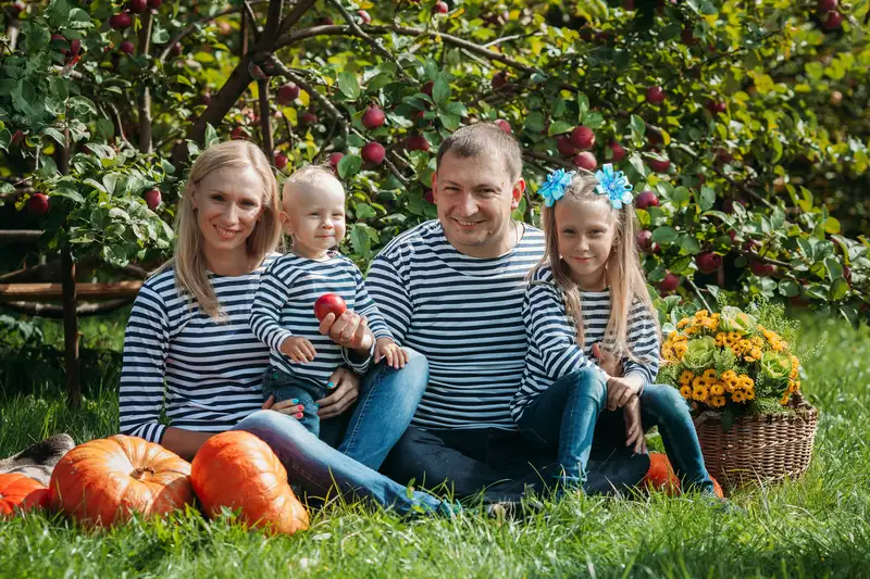 a family sitting on the grass